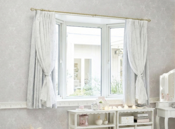 ボイルをリボンでまとめたグレーの柄の遮光カーテンを腰高窓に設置した画像